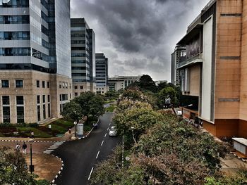 Buildings in city against cloudy sky