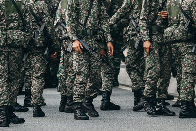 Low section of army soldiers on road