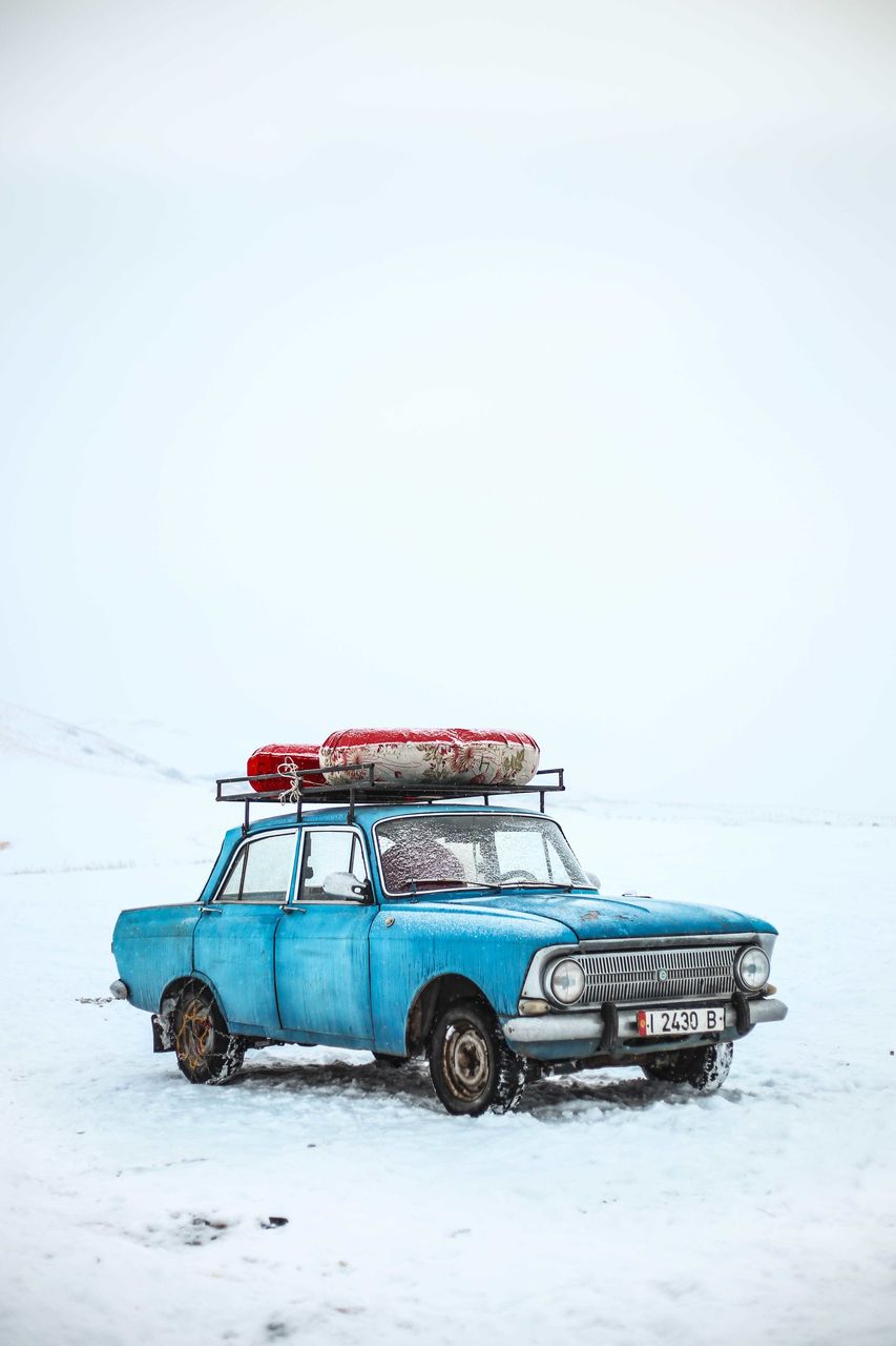 CAR PARKED ON SNOW FIELD