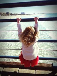 Woman sitting on pier