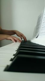 Cropped hands playing piano