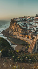 High angle view of sea and buildings against sky