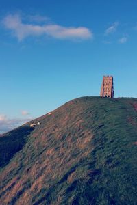 Low angle view of castle on mountain against sky