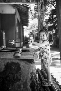 Portrait of cute girl standing in shrine