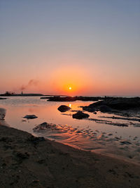 Scenic view of sea against romantic sky at sunset