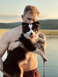 Portrait of woman holding dog