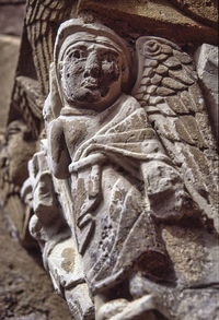 Close-up of buddha statue against wall