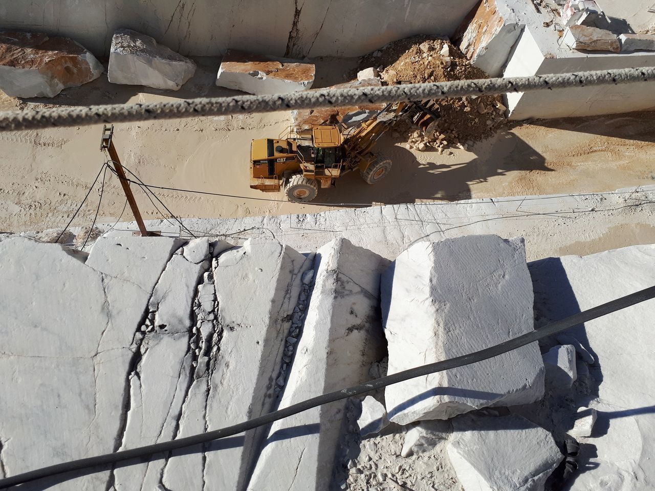 HIGH ANGLE VIEW OF DAMAGED BICYCLE ON METAL BUILDING