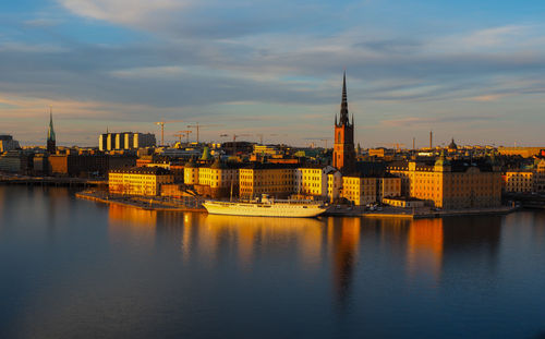 View of buildings at waterfront during sunset