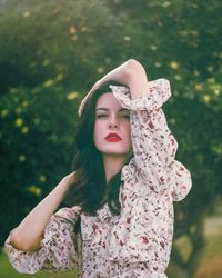 Portrait of woman standing against plants