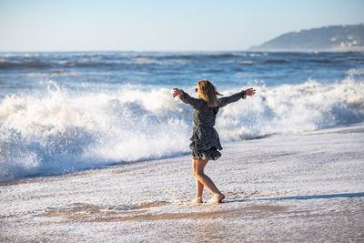 Full length of woman walking on beach