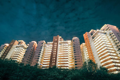 High angle view of modern buildings against blue sky