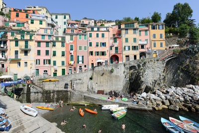 Boats in canal amidst buildings in city