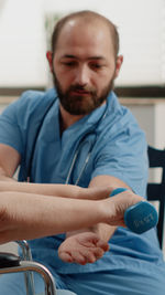 Doctor assisting patient in work out