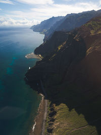 Aerial view of sea and mountains against sky