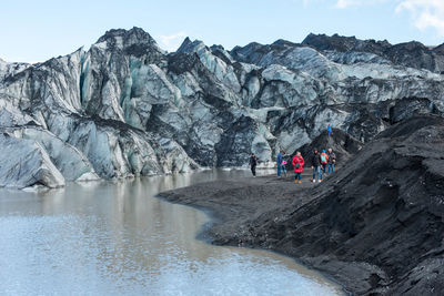 Tourists making a glacier hiking with a private tour guide in the solheimajokull, iceland