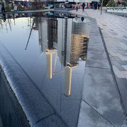 Reflection of buildings on puddle