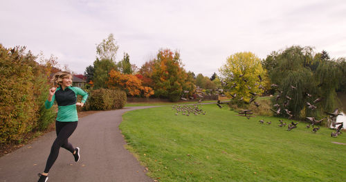 Full length of woman on grass against sky