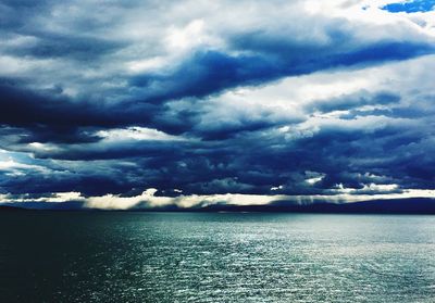 Scenic view of sea against storm clouds