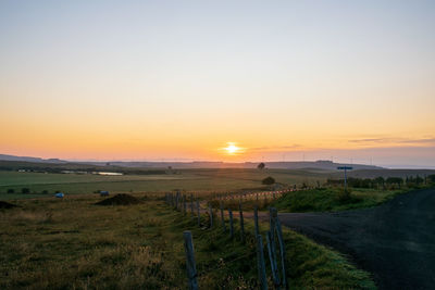 Scenic view of field against sky during sunset