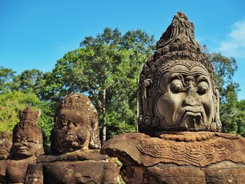 Low angle view of buddha statue against sky