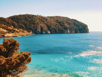 Scenic view of rocks in sea against sky