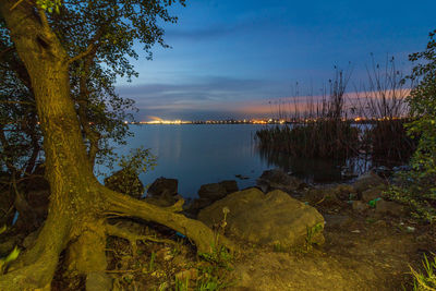 Scenic view of lake against sky during sunset