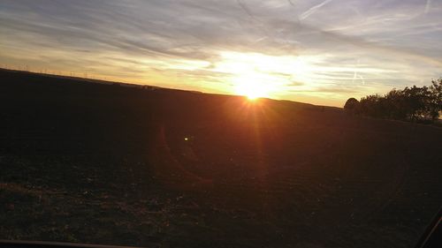 Scenic view of field against sky during sunset