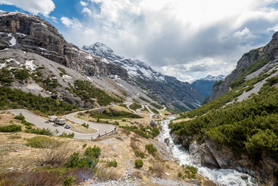 Scenic view of river amidst mountains against sky