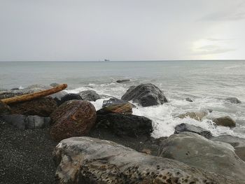 Rocks on beach against sky