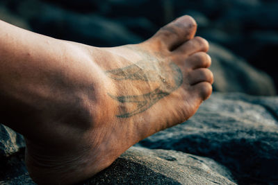 Close-up of man hand on rock