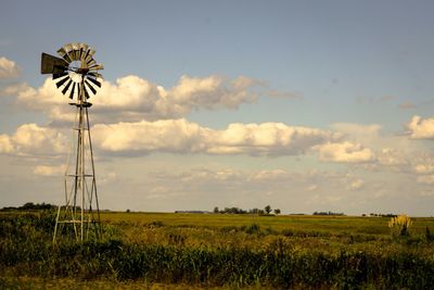 Scenic view of field against cloudy sky