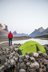 Climber enjoys view of summit lake from his campsite in akshayak pass