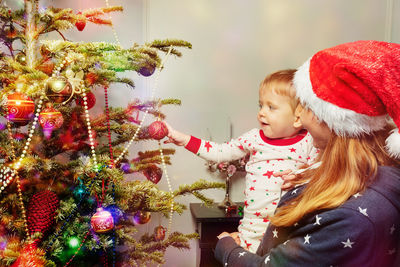 Portrait of girl decorating christmas tree