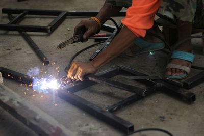 Man working on metal grate