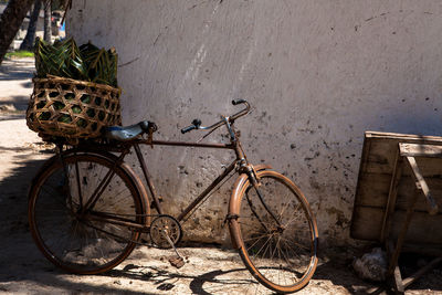 Basket on bicycle against wall