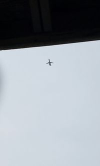 Low angle view of airplane against clear sky