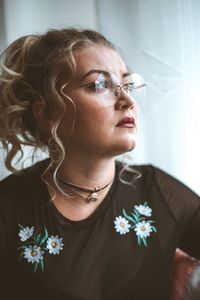 Close-up portrait of young woman looking away