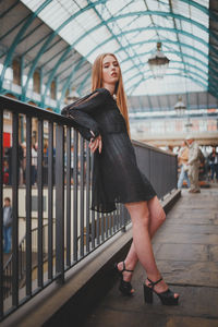 Full length of woman standing against the wall