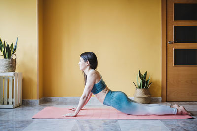 Woman sitting on floor at home