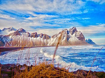 Panoramic view of frozen lake against cloudy sky