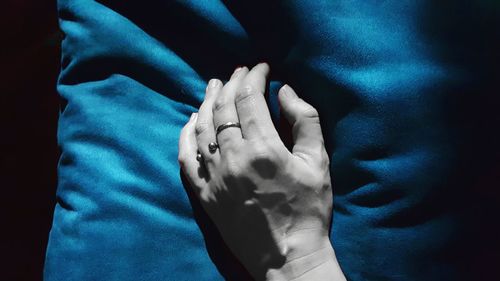 Close-up of hands against blue background