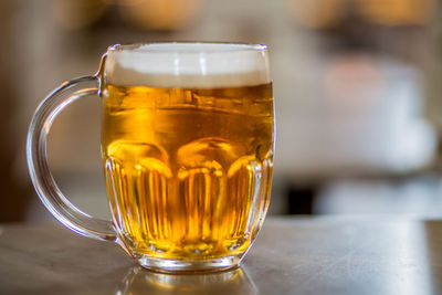 Close-up of beer glass on table