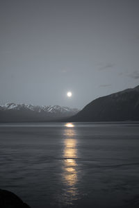 Scenic view of sea and mountains against sky