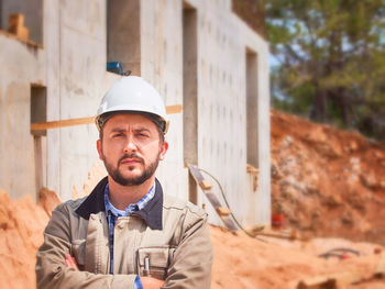 Portrait of man standing at construction site