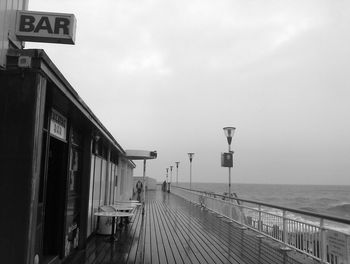 Street amidst sea against sky