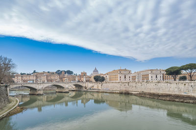 The tiber river in rome in italy at the bottom of st. peter's dome