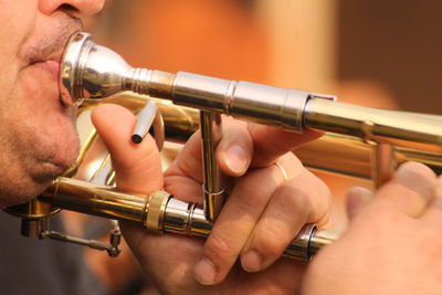 Close-up of man playing trumpet