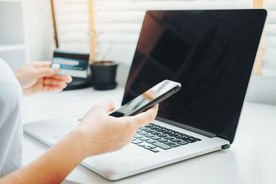 Midsection of woman using mobile phone