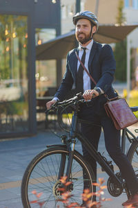 Portrait of young man riding bicycle on street